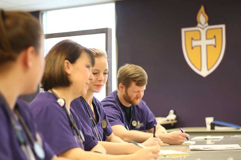 Accelerated BSN students in class working at desk