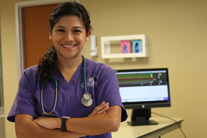 CTX ABSN student in purple scrubs