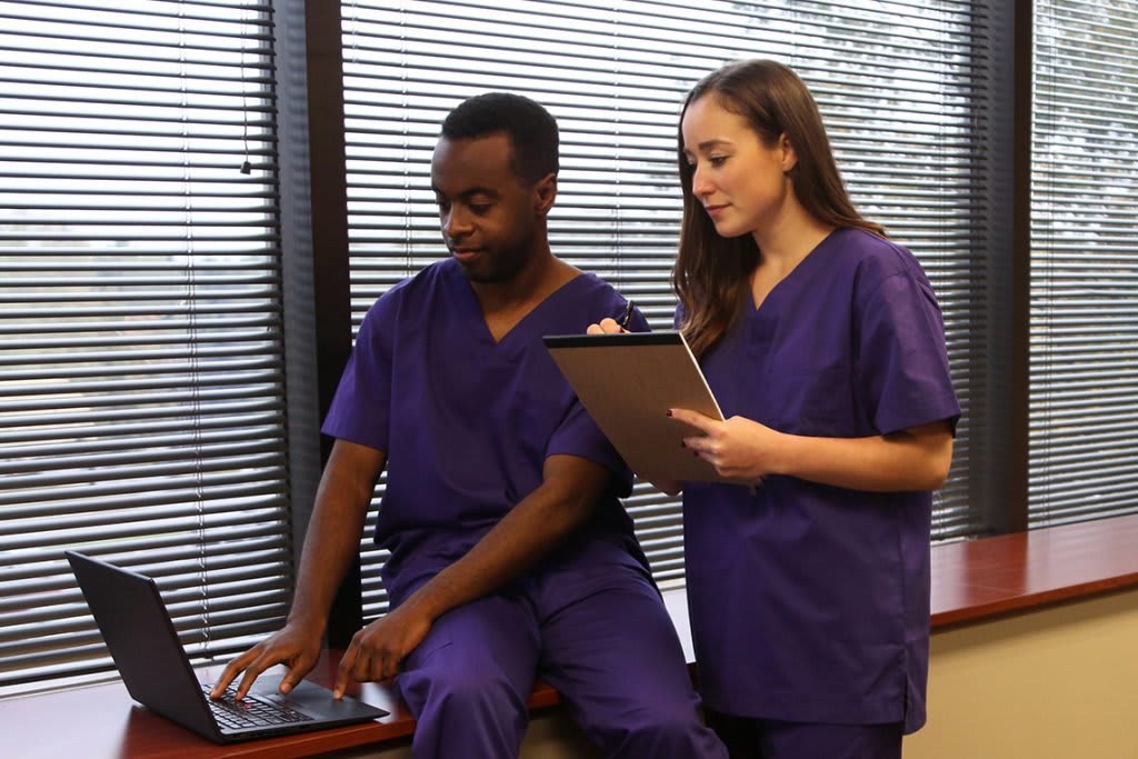 nursing students looking at laptop