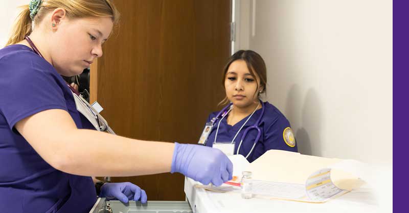 two CTX ABSN students using medical tools