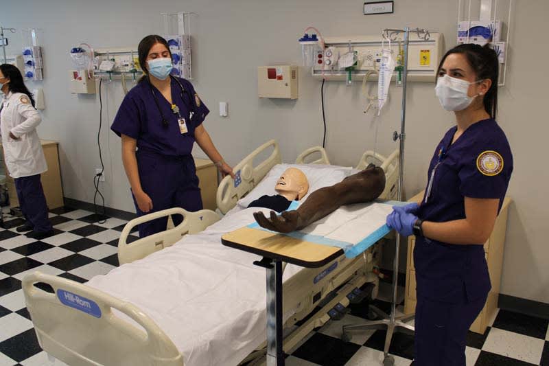 two CTX ABSN students working together in sim lab