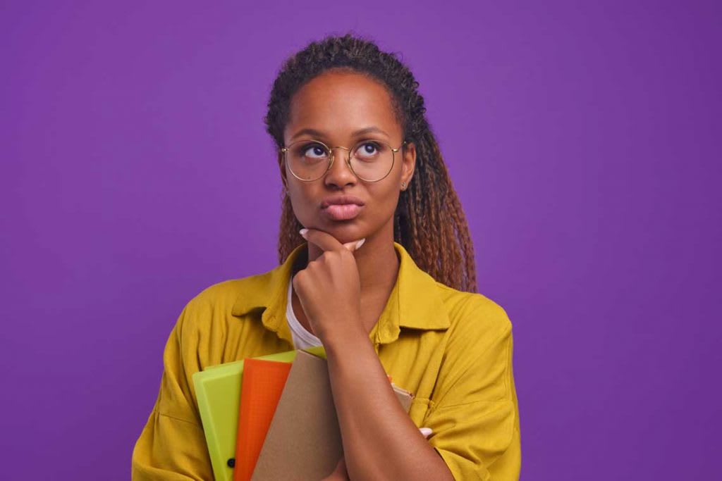 woman in yellow shirt standing and thinking