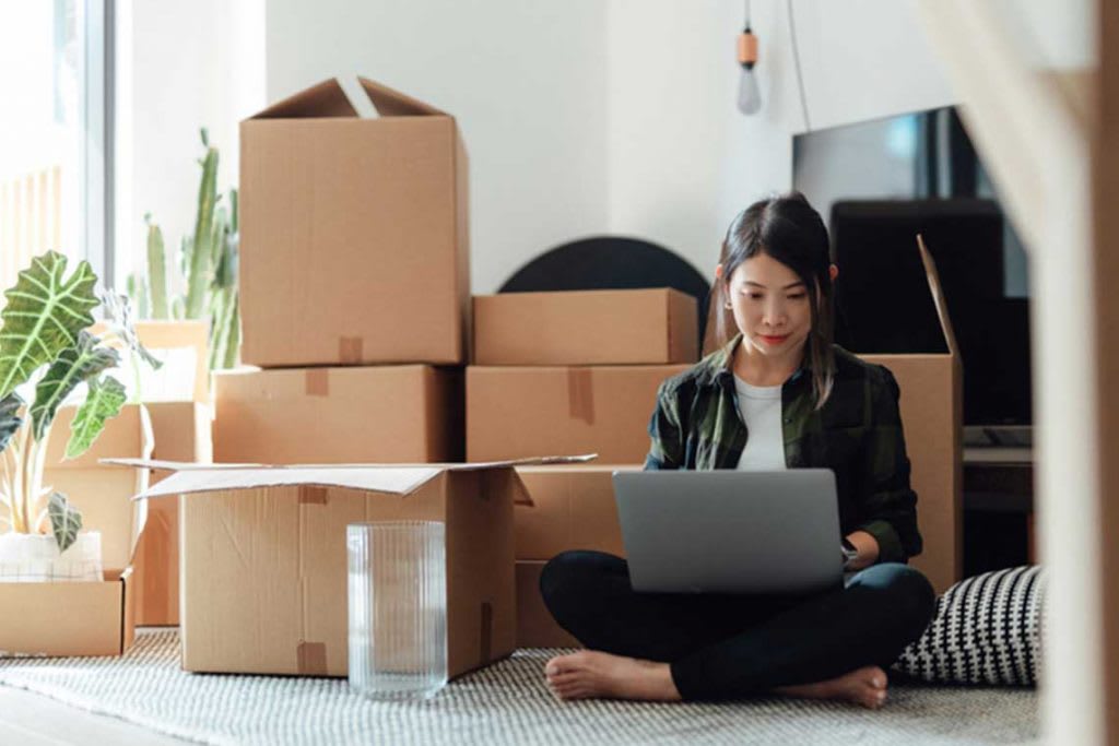 girl sitting in front of moving boxes