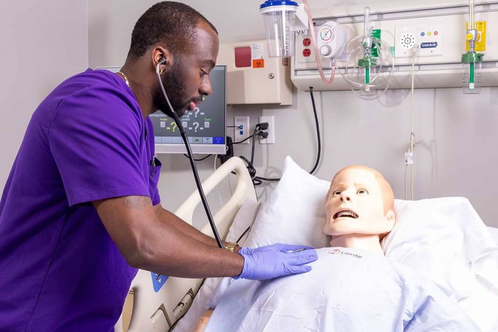 Concordia Texas nursing student working with sim manikin