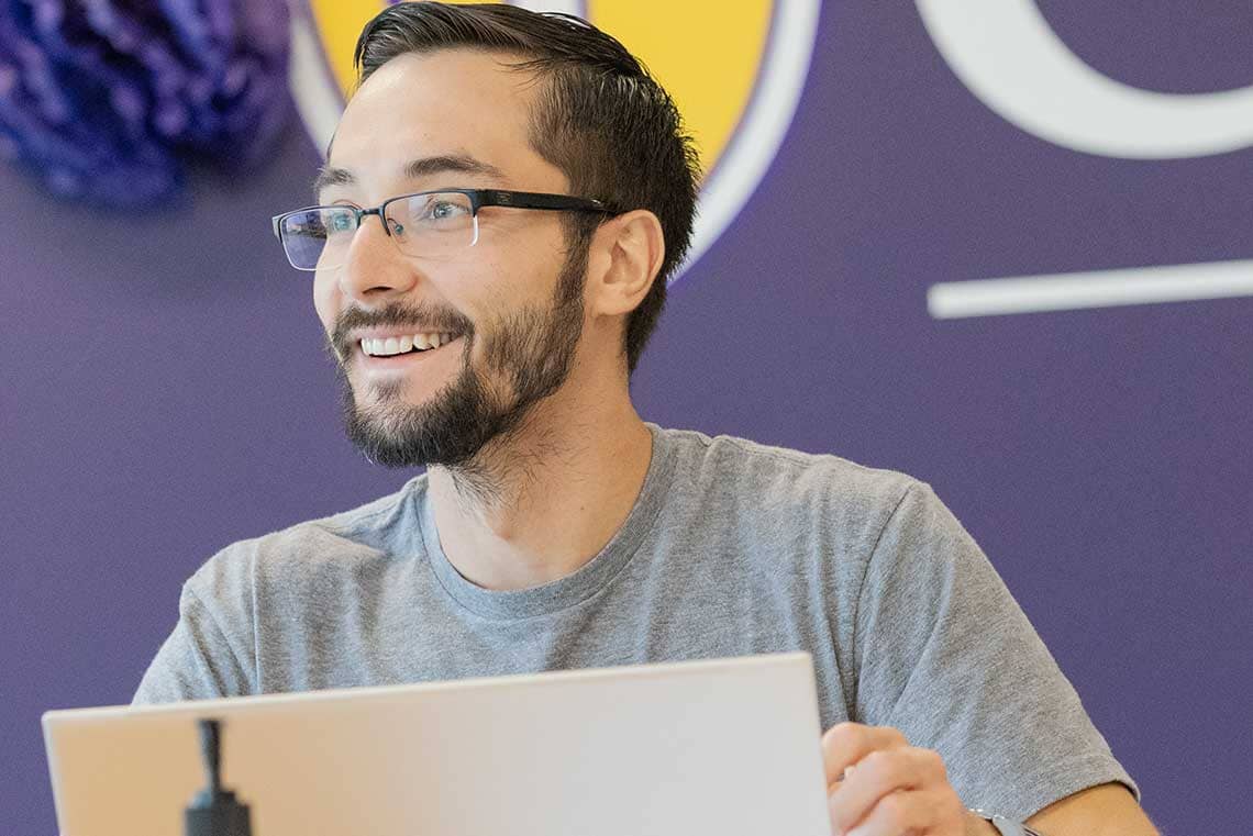 nursing student smiling using laptop