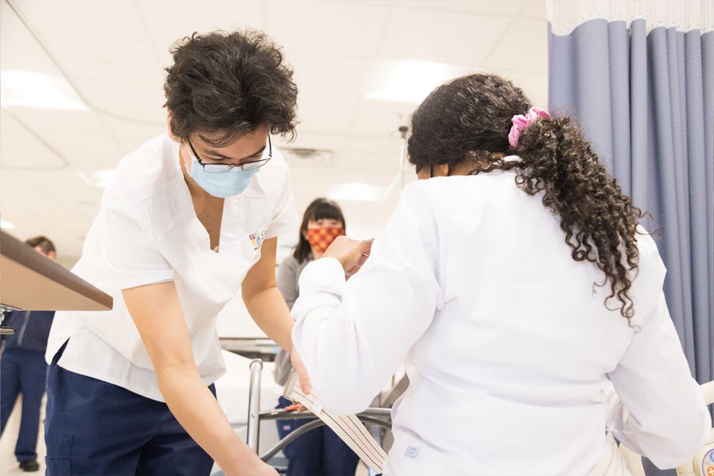 nursing students practicing skills in lab