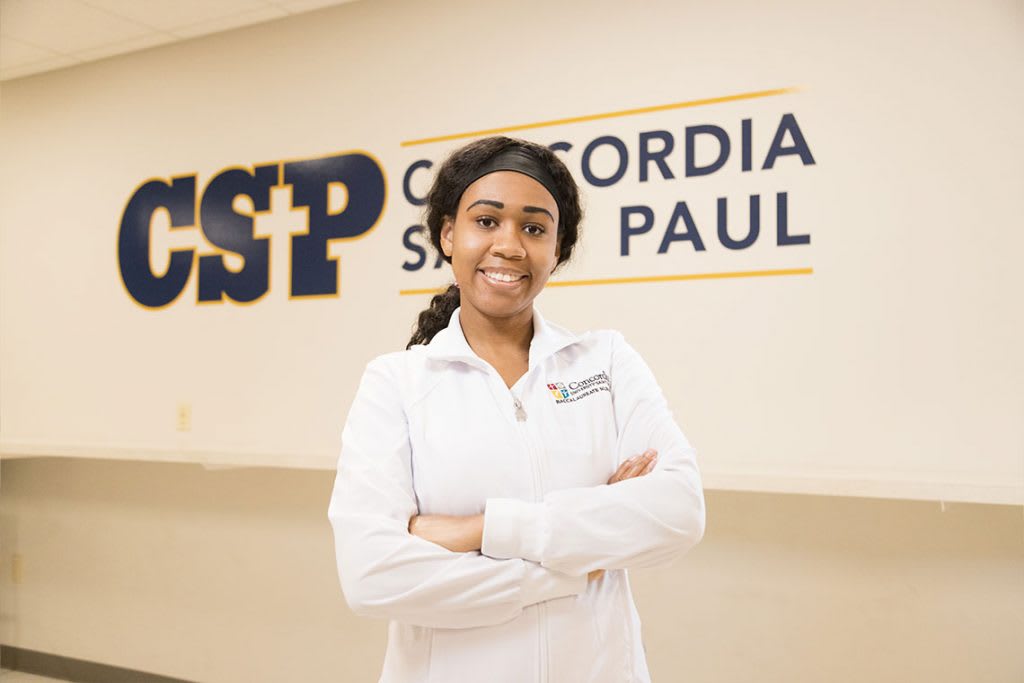 CSP nursing student smiling and holding arms crossed