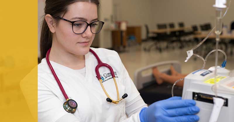 Concordia St. Paul ABSN student working with nursing lab equipment