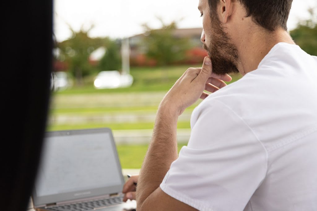 nursing student looking at laptop screen