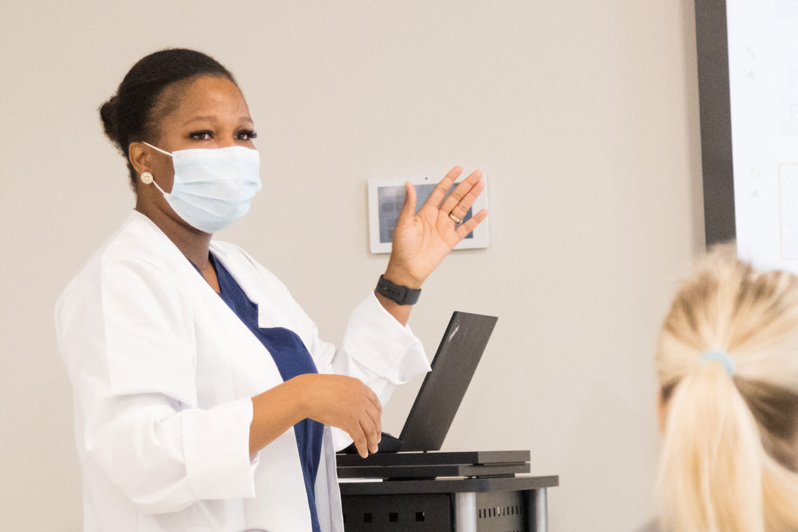 nursing instructor raising hand