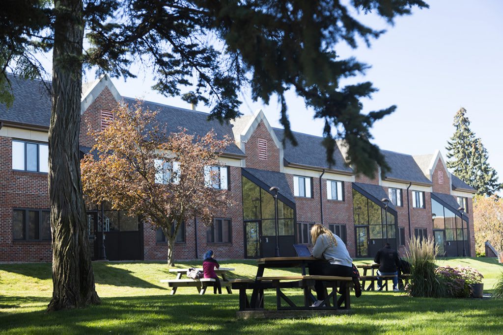 outdoor view of a building and people sitting on benches