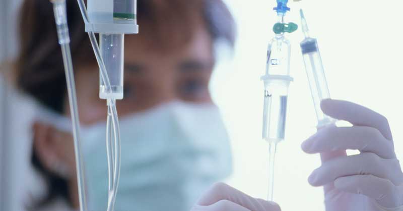 Closeup of nurse looking at an IV drip