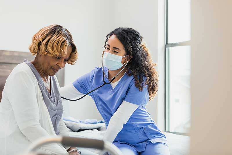 cardiac nurse checking patient heartbeat