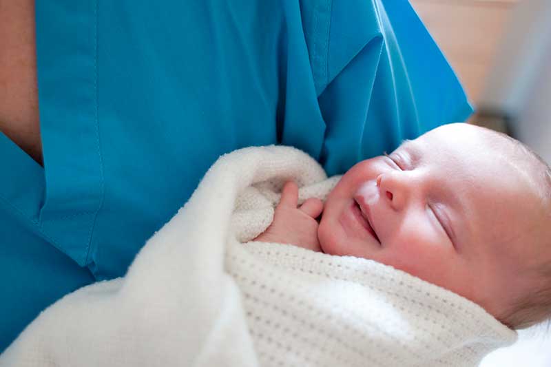 neonatal nurse holding baby