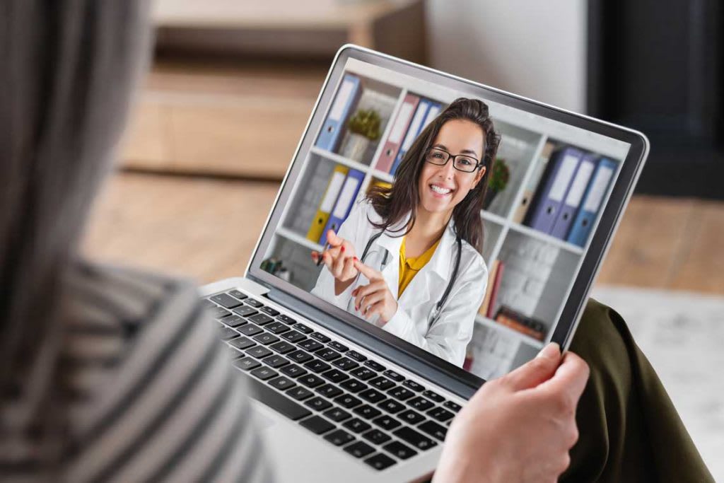 Telehealth nurse speaking on laptop screen