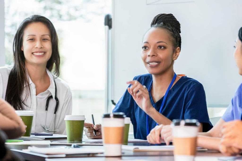 nurse at table meeting other nurses