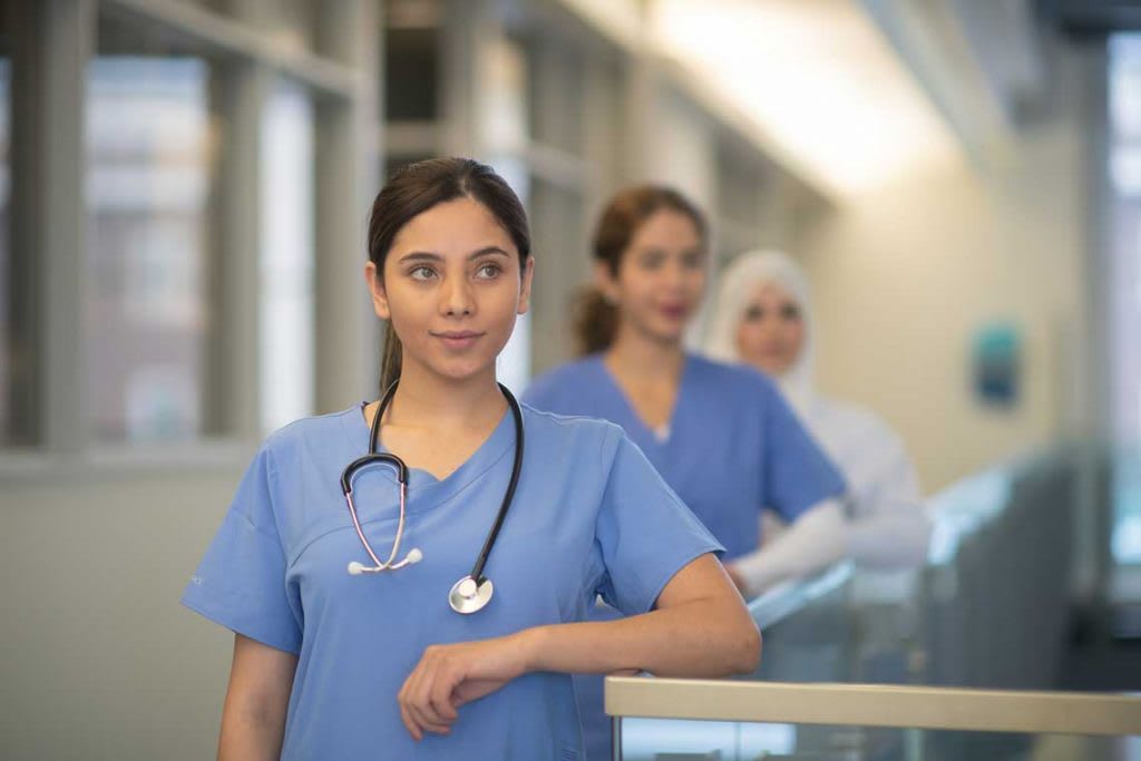 nurses standing at desk counter