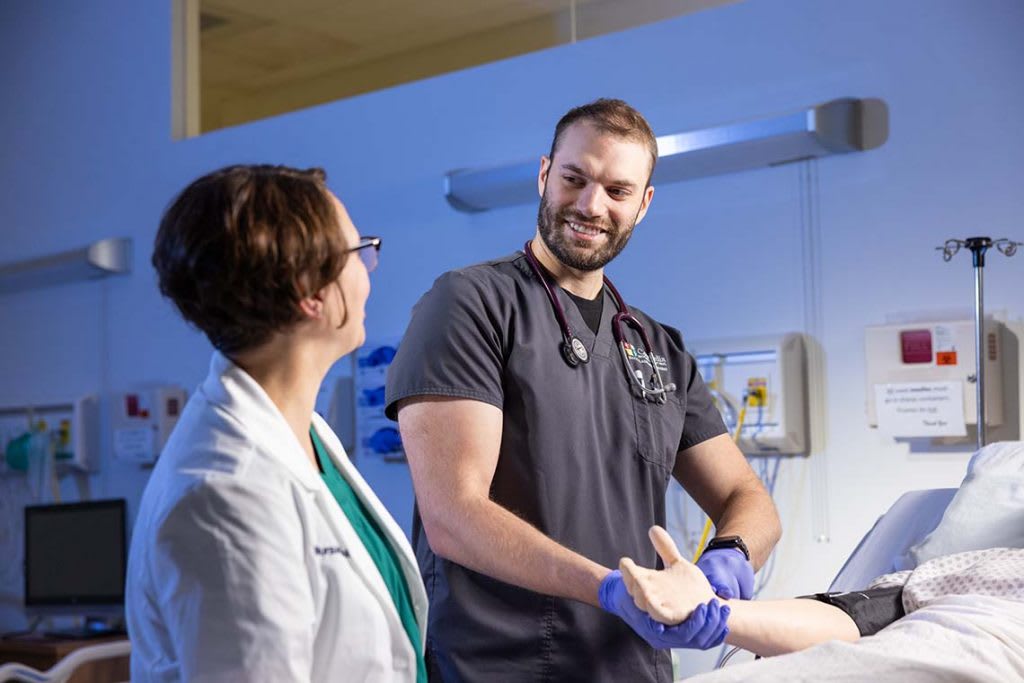 nurses helping patient