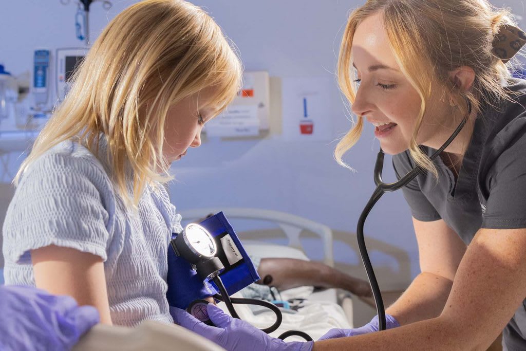 student nurse with child patient