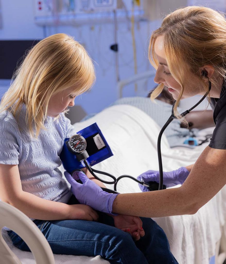 nursing student treating patient