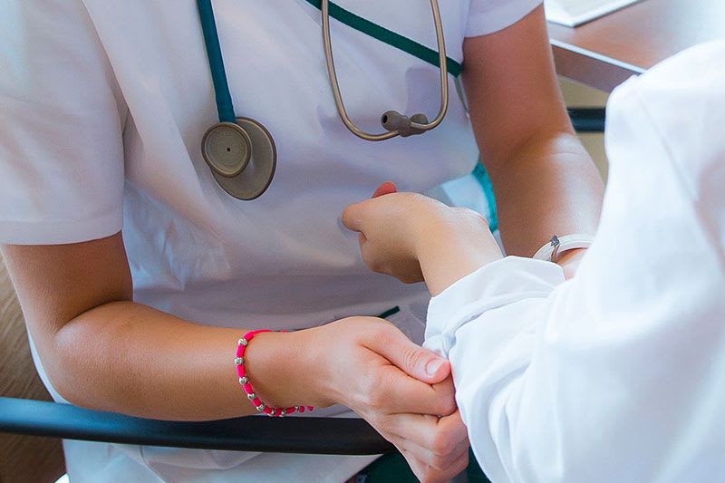 Nurse assisting patient