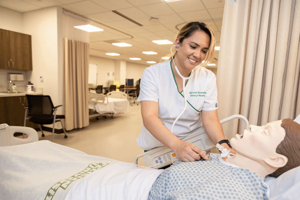 Felician using stethoscope on sim manikin