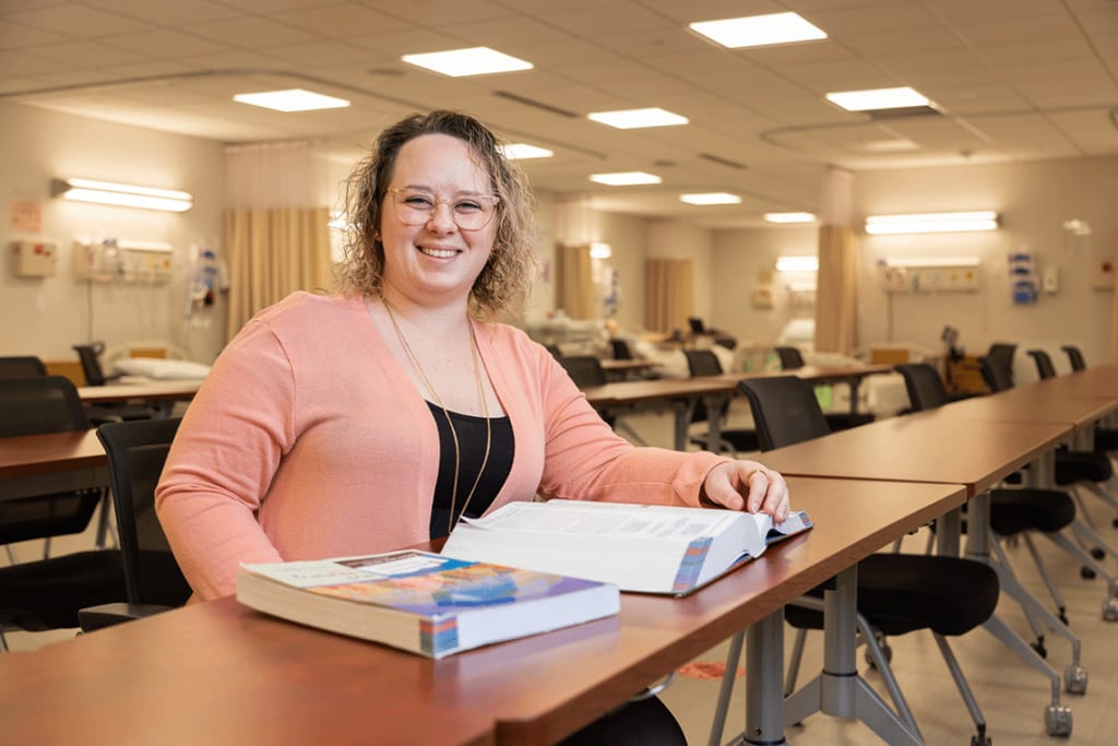 Felician nursing student sitting at desk with textbooks