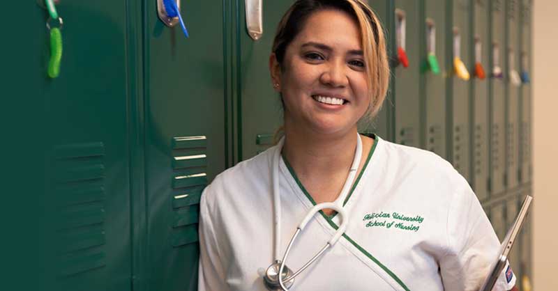 Felician University ABSN student standing by lockers