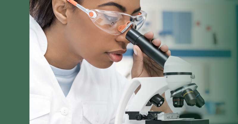 nursing student using microscope