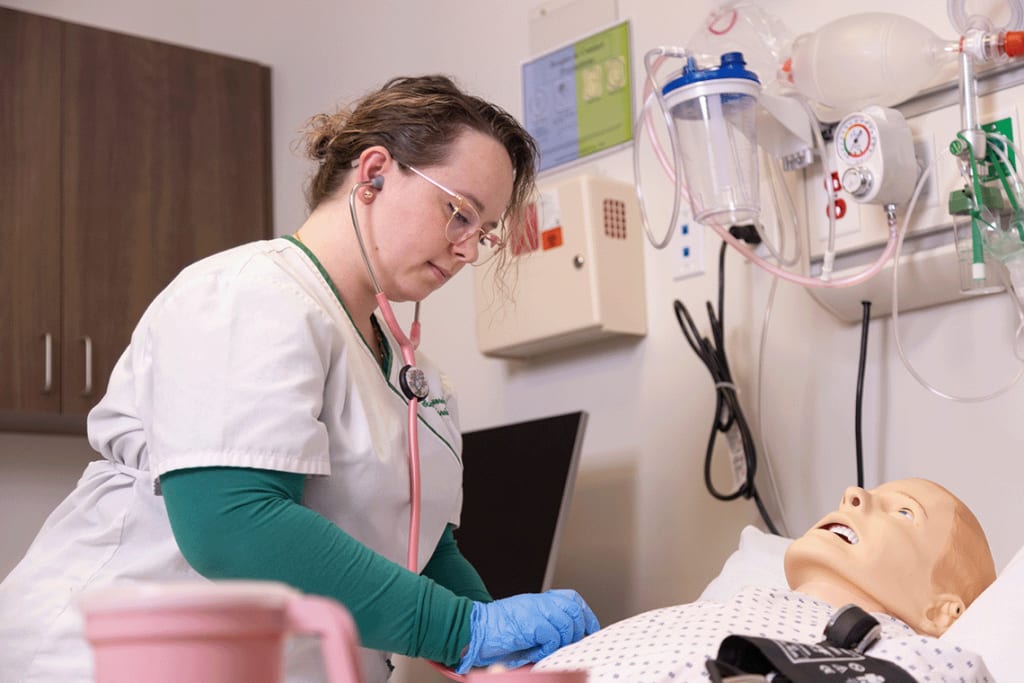 Felician nursing student working with simulation manikin