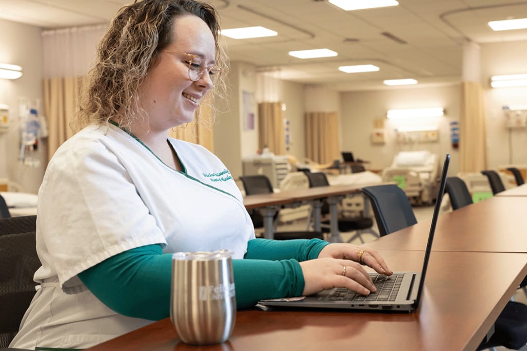 Felician nursing student typing on laptop