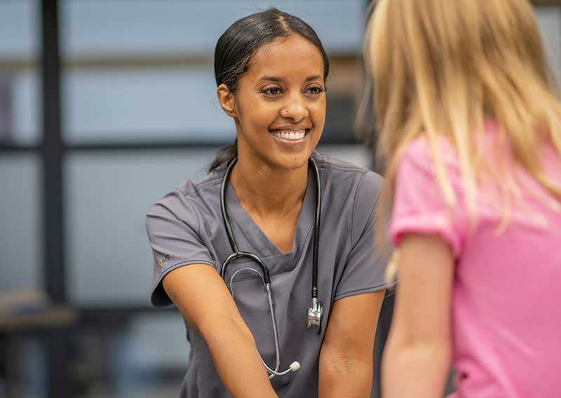 school nurse sitting with child patient