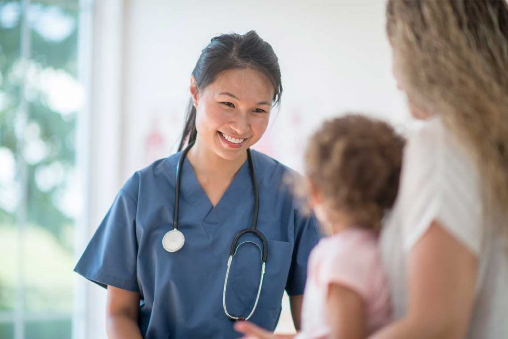 nurse smiling at child patient