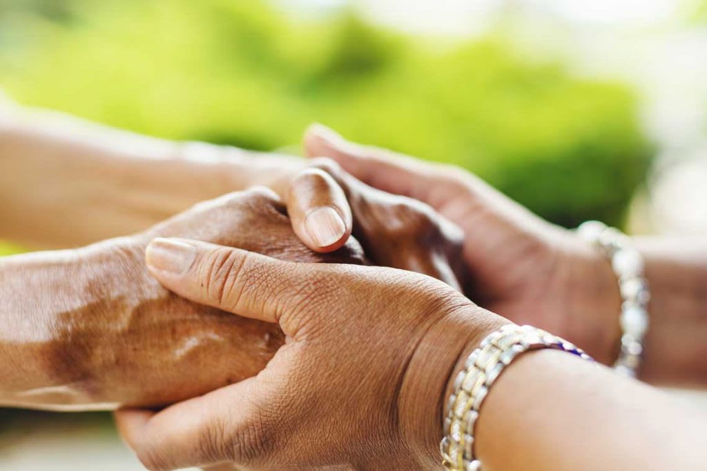 pair of hands holding another pair of hands