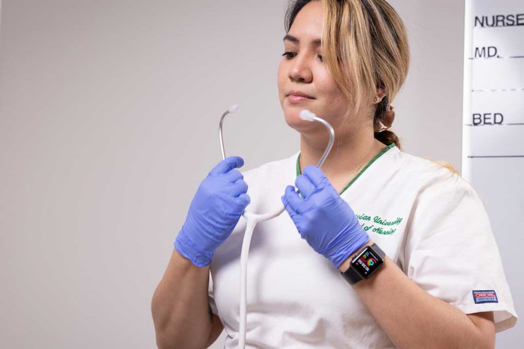 Felician nursing student using a stethoscope