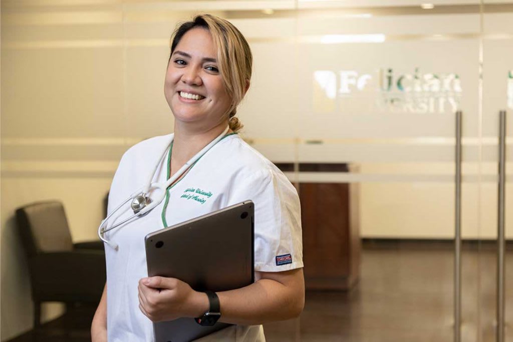 Felician nurse holding laptop