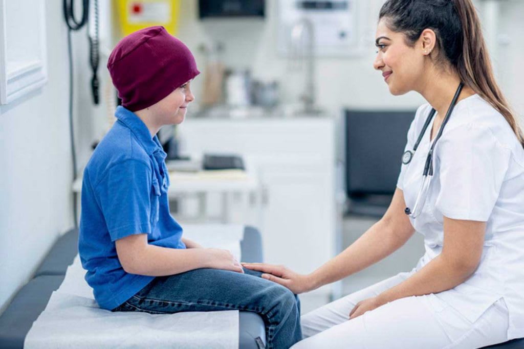 nurse kneeling smiling at child