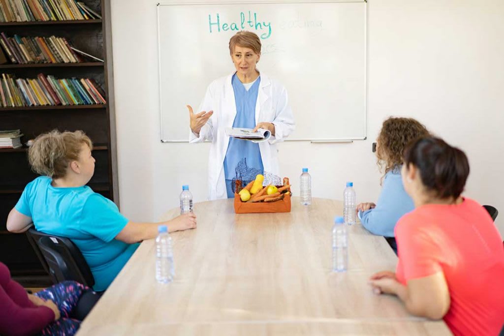 nurse speaking to room of people about eating healthy