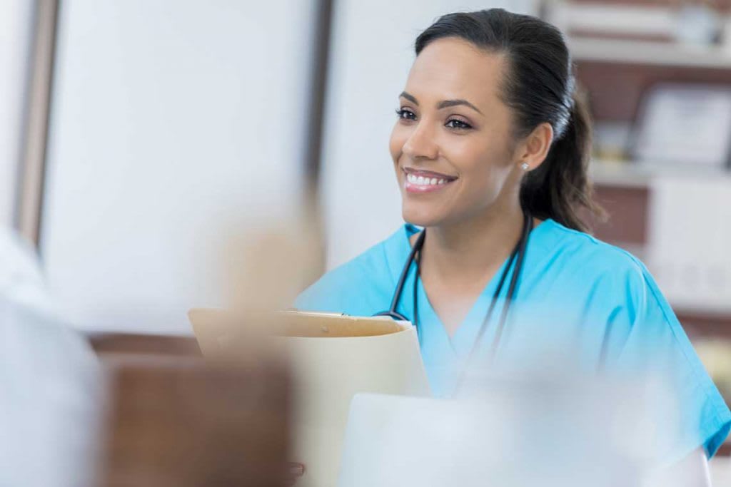 nurse sitting in interview holding a folder