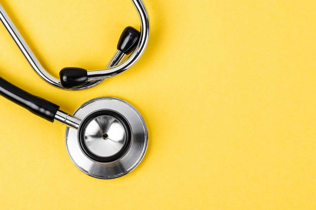 stethoscope on top of yellow background