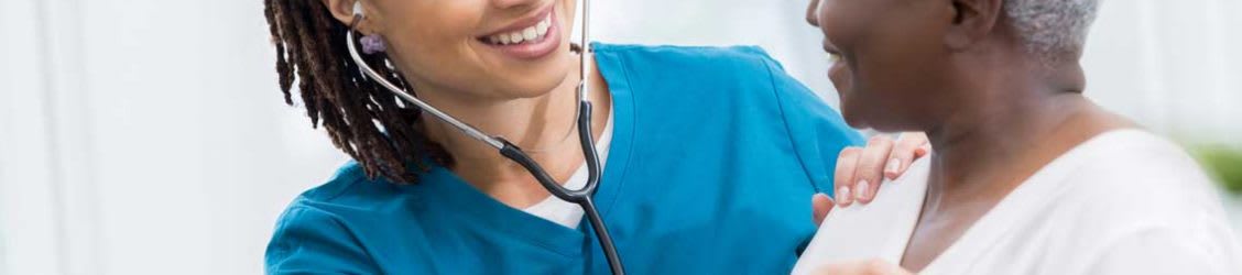 nurse listens to patient's heart rate