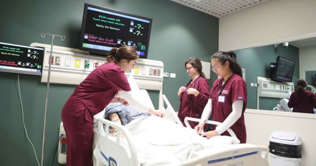 Loyola nursing students working in sim lab
