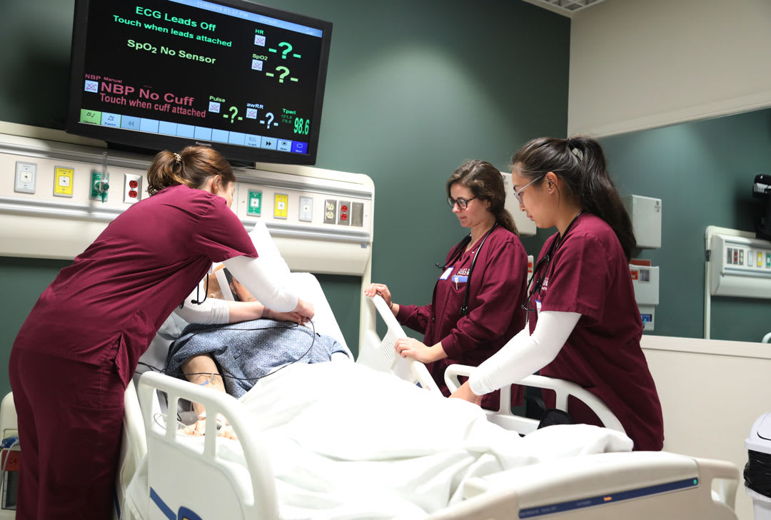 nursing student practicing in lab with manikin