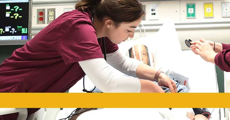Loyola ABSN nursing student working in sim lab