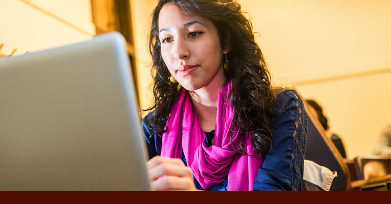 woman sitting at desk using computer