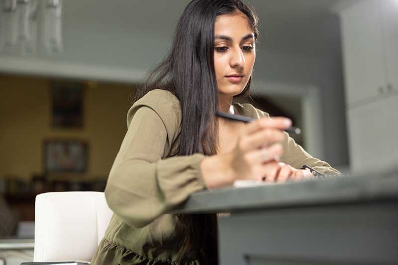 nursing student sitting at desk studying