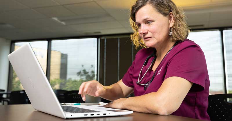 Loyola nursing student on laptop