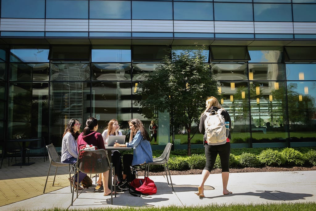 nursing students sitting outside and socializing