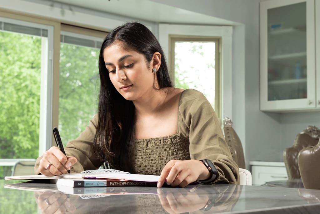 Student studying at kitchen table