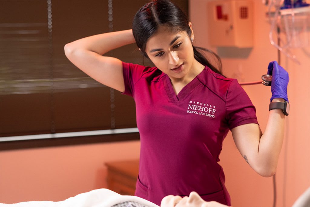 nursing student putting stethoscope on